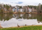 Thumbnail 14 of 31 - two standing next to a lake in front of a building
