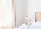 Thumbnail 8 of 8 - a bedroom with a bed and a nightstand with a lamp