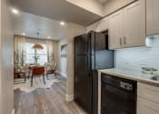 Thumbnail 9 of 20 - the kitchen and dining room of a home with a black refrigerator