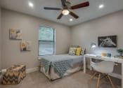 Thumbnail 13 of 20 - a bedroom with a bed and a ceiling fan