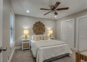 Thumbnail 15 of 20 - a bedroom with a large bed and a ceiling fan