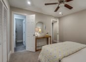 Thumbnail 16 of 20 - a bedroom with a bed and a ceiling fan
