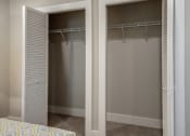 Thumbnail 14 of 20 - a bedroom with two closets and a bed