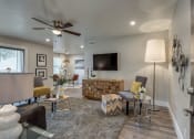 Thumbnail 1 of 20 - a living room with a ceiling fan and a tv