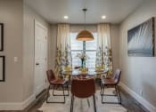 Thumbnail 6 of 20 - a dining room with a table and chairs in front of a window