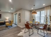 Thumbnail 7 of 20 - a dining room and living room with a table and chairs