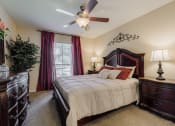 Thumbnail 9 of 18 - a bedroom with a large bed and a ceiling fan