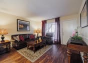 Thumbnail 5 of 18 - a living room with a leather couch and a coffee table