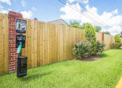 Thumbnail 19 of 22 - a backyard with a wooden fence and a sign in the grass