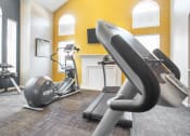 Thumbnail 4 of 22 - a gym with treadmills and exercise equipment at the district at highland village