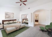 Thumbnail 14 of 22 - a bedroom with a bed and a ceiling fan