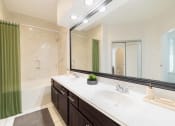 Thumbnail 15 of 22 - a bathroom with two sinks and a large mirror