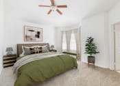 Thumbnail 16 of 22 - a bedroom with a bed and a ceiling fan