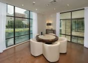 Thumbnail 17 of 23 - a living room with large windows and a table