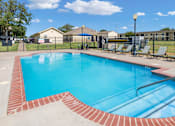 Thumbnail 8 of 23 - A small pool with a red brick border.