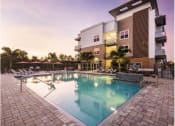 Thumbnail 25 of 45 - a swimming pool in front of an apartment building