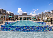 Thumbnail 14 of 33 - A large blue tiled pool in the middle of a building complex.