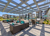 Thumbnail 17 of 33 - A patio with a white canopy and grey couches.