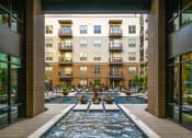 Thumbnail 9 of 30 - a swimming pool with a view of an apartment building in the background