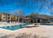 Thumbnail 28 of 36 - a swimming pool with a house in the background