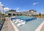 Thumbnail 15 of 33 - A pool with a blue tiled edge and white lounge chairs.