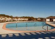 Thumbnail 12 of 15 - a swimming pool with apartments in the background