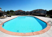 Thumbnail 11 of 15 - a large swimming pool with apartments in the background