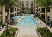 Thumbnail 21 of 23 - a large swimming pool in the middle of an apartment building