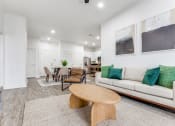 Thumbnail 9 of 21 - a living room with a couch and a table