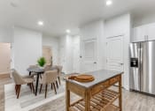 Thumbnail 5 of 21 - a kitchen with a table and chairs and a refrigerator