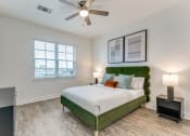 Thumbnail 10 of 21 - a bedroom with a green and white bed and a ceiling fan
