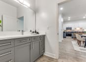 Thumbnail 12 of 21 - an open kitchen and dining area with a large mirror and a living room