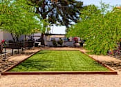 Thumbnail 24 of 26 - a backyard with a grassy area and a black fence