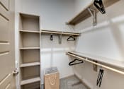 Thumbnail 7 of 32 - A white closet with a brown bag on the floor.