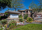 Thumbnail 27 of 28 - A ranch-style home with a stone sign in front.