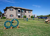 Thumbnail 28 of 28 - A green sign with two circles on it is in front of a building.