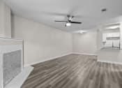 Thumbnail 3 of 29 - an empty living room with a ceiling fan and a fireplace