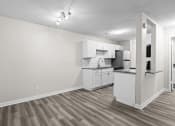 Thumbnail 2 of 29 - the living room and kitchen of an apartment with a wood floor and white cabinets