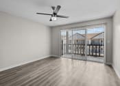 Thumbnail 5 of 29 - an empty living room with a large window and a ceiling fan