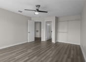 Thumbnail 6 of 29 - an empty living room with wood flooring and a ceiling fan