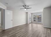 Thumbnail 4 of 29 - an empty living room with a ceiling fan and a window