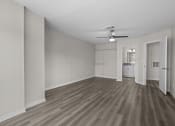 Thumbnail 8 of 29 - an empty living room with wood flooring and a ceiling fan