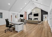 Thumbnail 12 of 24 - an open living room with a desk and a fireplace