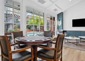 Thumbnail 14 of 24 - a dining room with a table and chairs and a large window