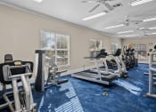 Thumbnail 20 of 26 - a gym with treadmills and other exercise equipment and windows