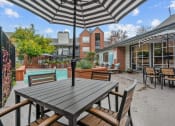 Thumbnail 20 of 24 - an outdoor patio with tables and chairs and a pool