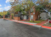 Thumbnail 23 of 24 - an empty street in front of a row of houses on a street
