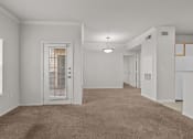 Thumbnail 3 of 26 - a spacious living room with a door to the kitchen and a carpeted floor