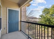 Thumbnail 11 of 26 - the entrance to a balcony with a blue door and a black railing
