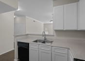 Thumbnail 5 of 26 - a kitchen with white cabinets and a sink